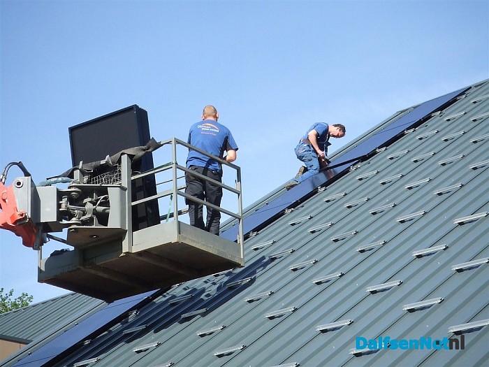 Dijkman bezig met het leggen van zonnepanelen