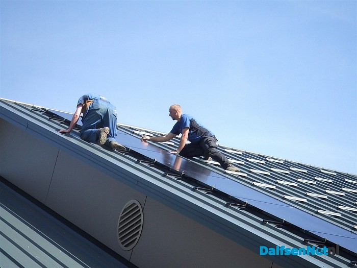 Dijkman bezig met het leggen van zonnepanelen